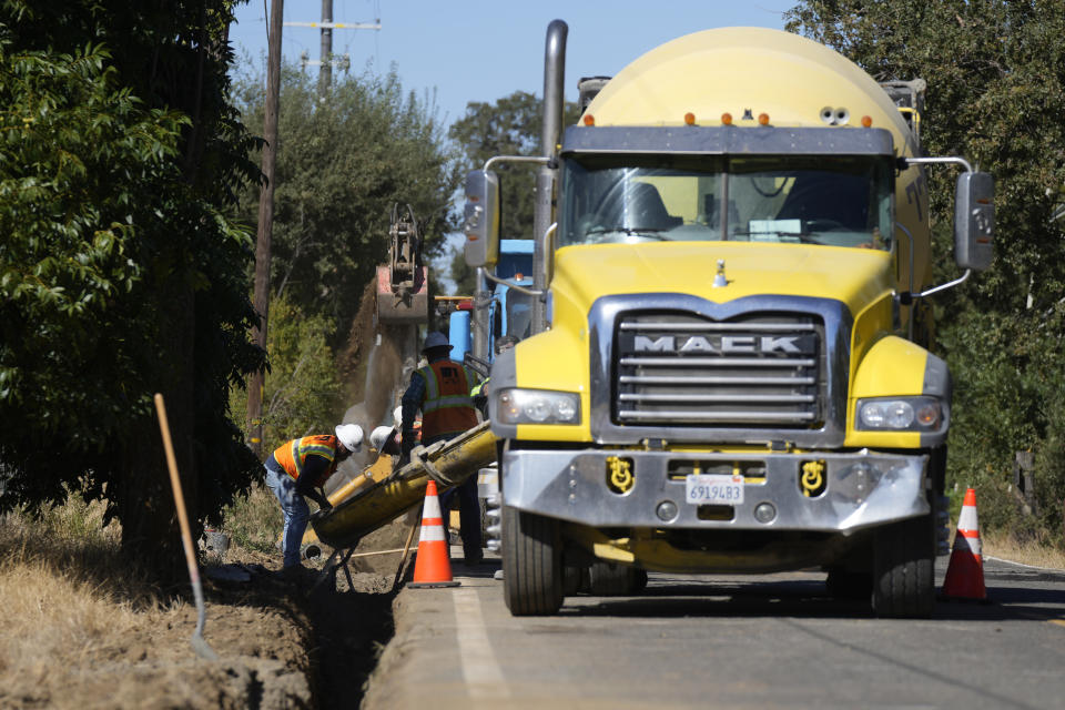 A Pacific Gas and Electric crew works on burying power lines in Vacaville, Calif., Wednesday, Oct. 11, 2023. PG&E wants to bury many of its power lines in areas threatened by wildfires. (AP Photo/Jeff Chiu)