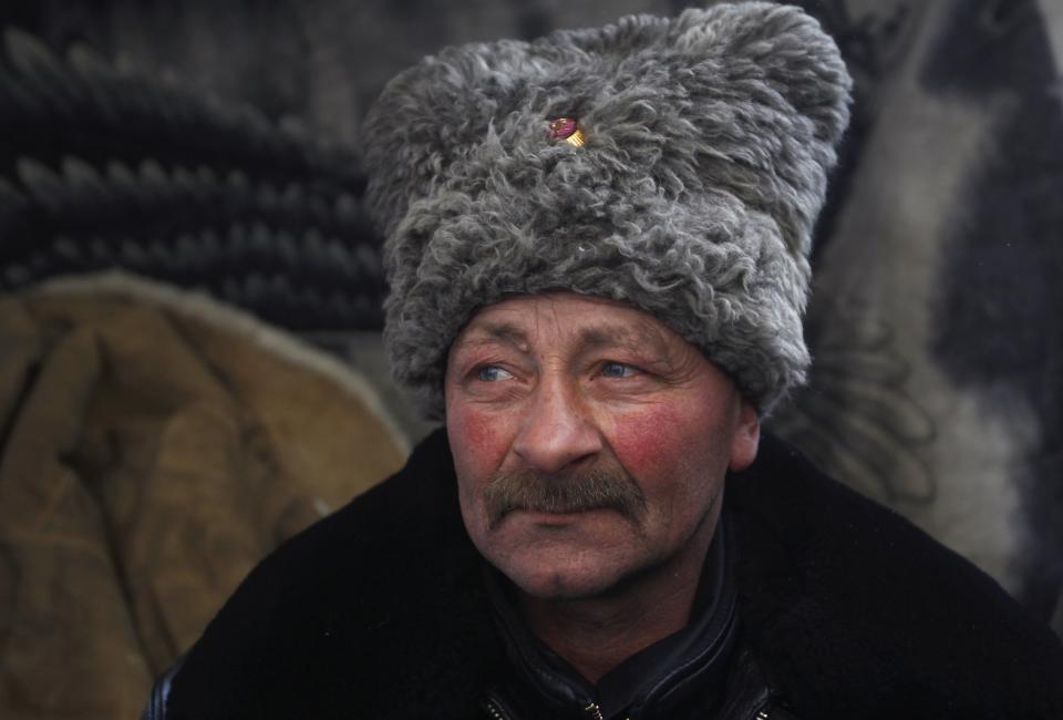 A Cossack poses for a picture in a demonstrators' camp during a rally held by anti-government protesters in Independence Square in central Kiev