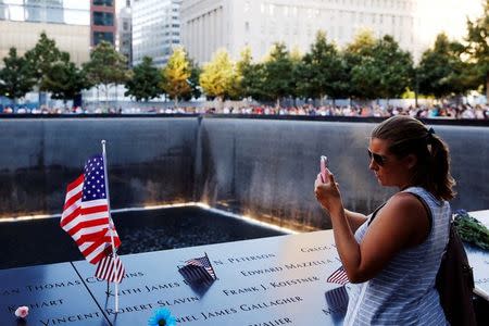 A visitor photographs the National September 11 Memorial and Museum on the 15th anniversary of the 9/11 attacks in Manhattan, New York, U.S. on September 11, 2016. REUTERS/Lucas Jackson/File Photo