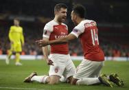 Arsenal's Sokratis Papastathopoulos, left, celebrates with Arsenal's Pierre-Emerick Aubameyang after scoring his side's third goal during the Europa League round of 32 second leg soccer match between Arsenal and Bate at the Emirates stadium in London, Thursday, Feb. 21, 2019. (AP Photo/Matt Dunham)