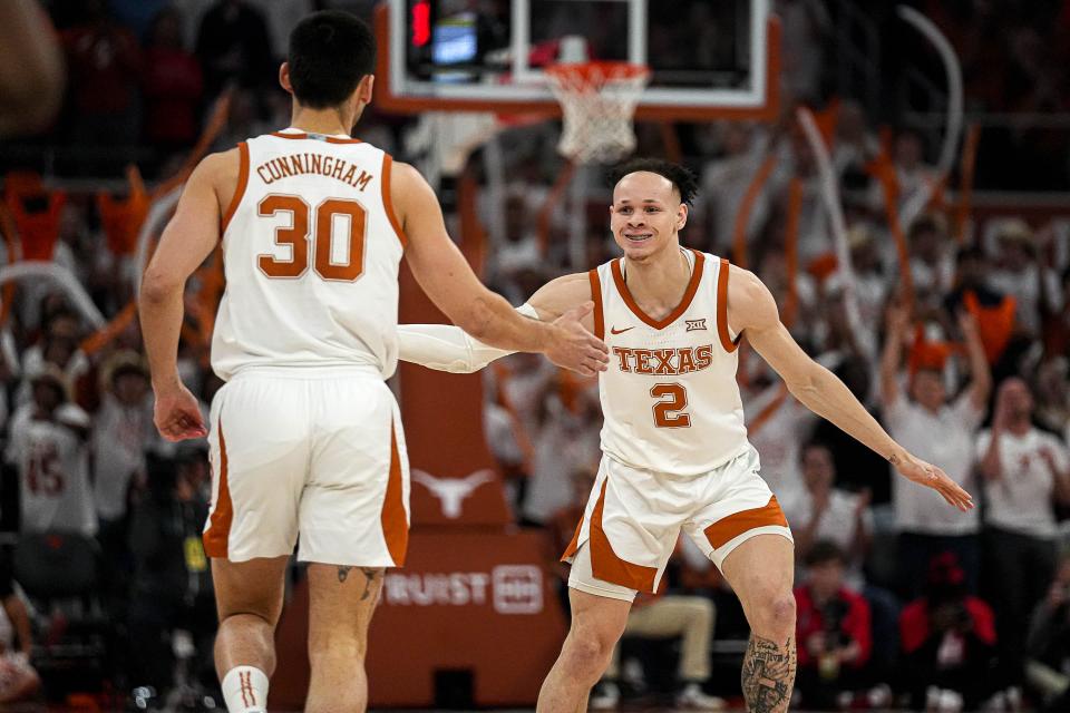 Texas guard Chendall Weaver, right, celebrates a 3-pointer by Brock Cunningham during Monday night's overtime loss to Houston.