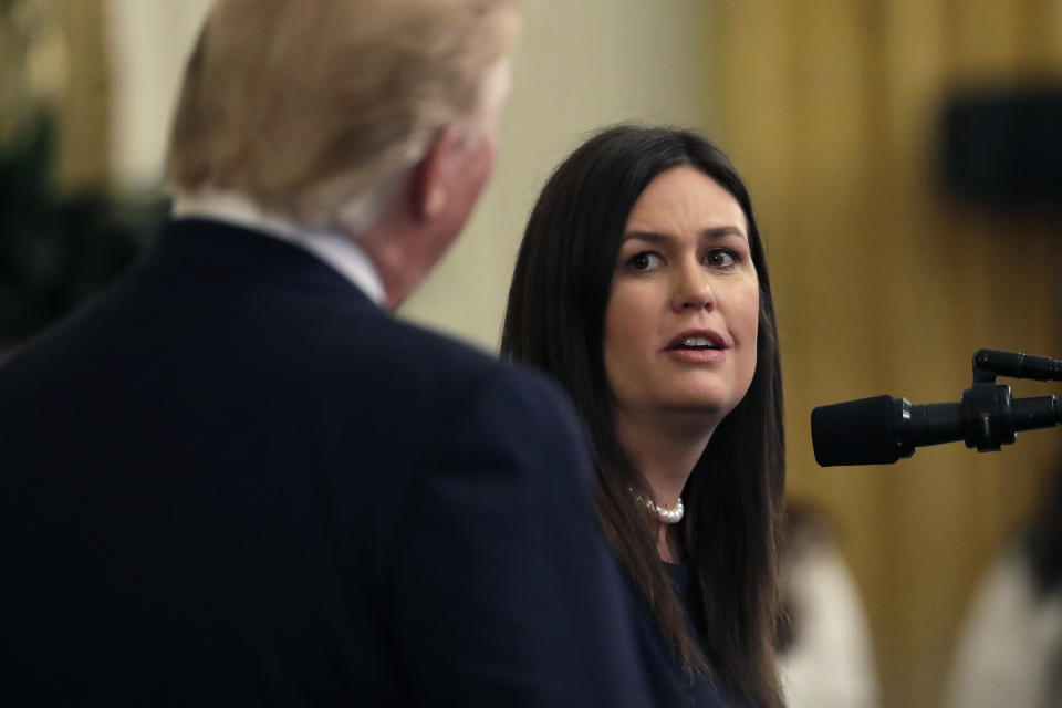 White House press secretary Sarah Sanders looks to President Donald Trump as she speaks during an event on second chance hiring in the East Room of the White House, Thursday, June 13, 2019, in Washington. Sanders is leaving her job at the end of the month. (AP Photo/Evan Vucci)