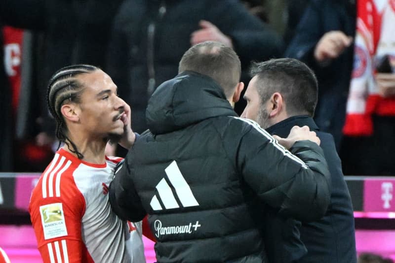 Union coach Nenad Bjelica (R) grabs Bayern Munich's Leroy Sane (L) in the face during the German Bundesliga soccer match between Bayern Munich - 1. FC Union  at the Allianz Arena. Sven Hoppe/dpa