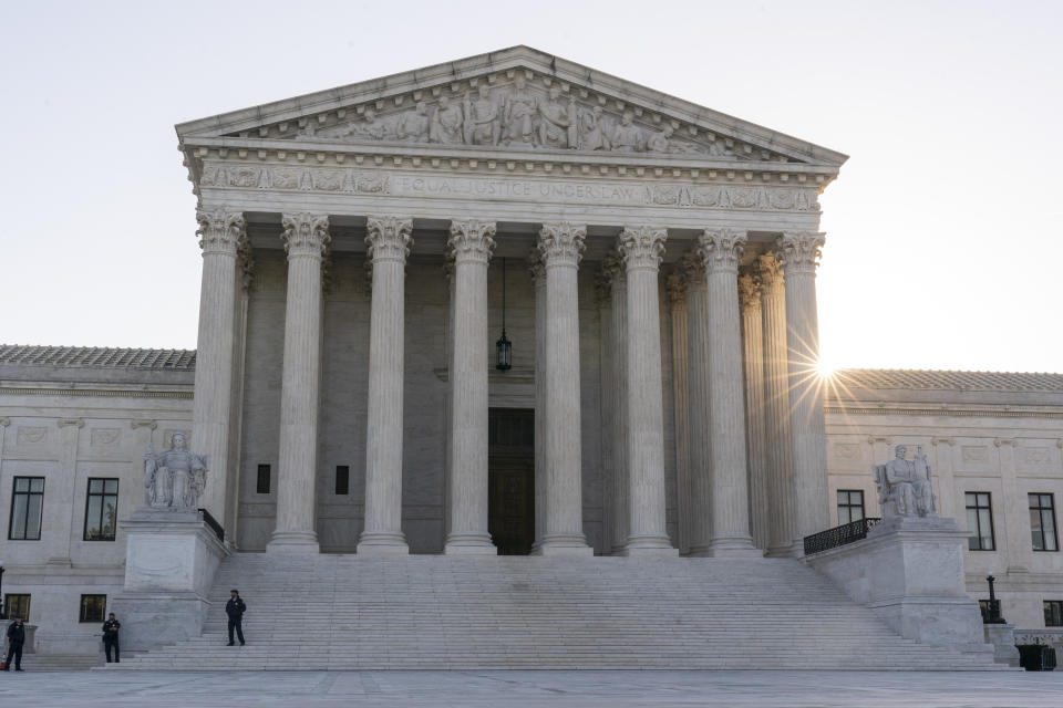 The sun rises behind the U.S. Supreme Court, Tuesday, Oct. 11, 2022, in Washington. The Biden administration on Tuesday urged the Supreme Court to steer clear of a legal fight over classified documents seized during an FBI search of former President Donald Trump's Florida estate. (AP Photo/Alex Brandon)