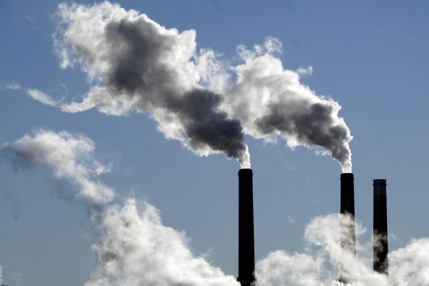 FILE - Steam is emitted from smoke stacks at a coal-fired power plant Nov. 17, 2021, in Craig, Colo. President Joe Biden is promising "strong executive action" to combat climate change, despite dual setbacks that have restricted his ability to regulate carbon emissions and boost clean energy such as wind and solar power. (AP Photo/Rick Bowmer, File)