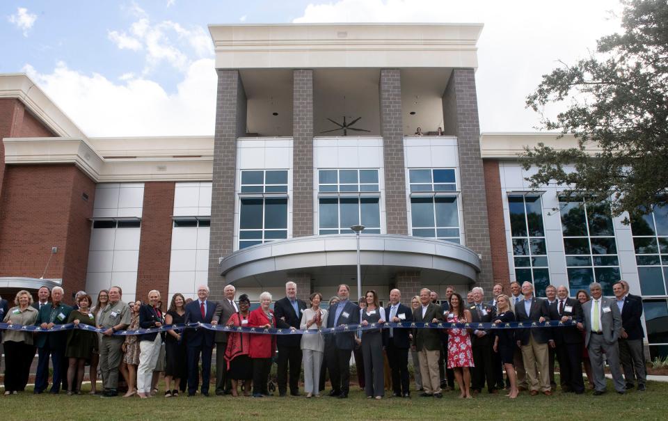 Pensacola State College's president, board and benefactors gather outside the college's new Bear Jones Moore Reeves Center for Math and Advanced Technology to officially dedicate the new multi-million dollar facility on Monday, Oct. 30, 2023.