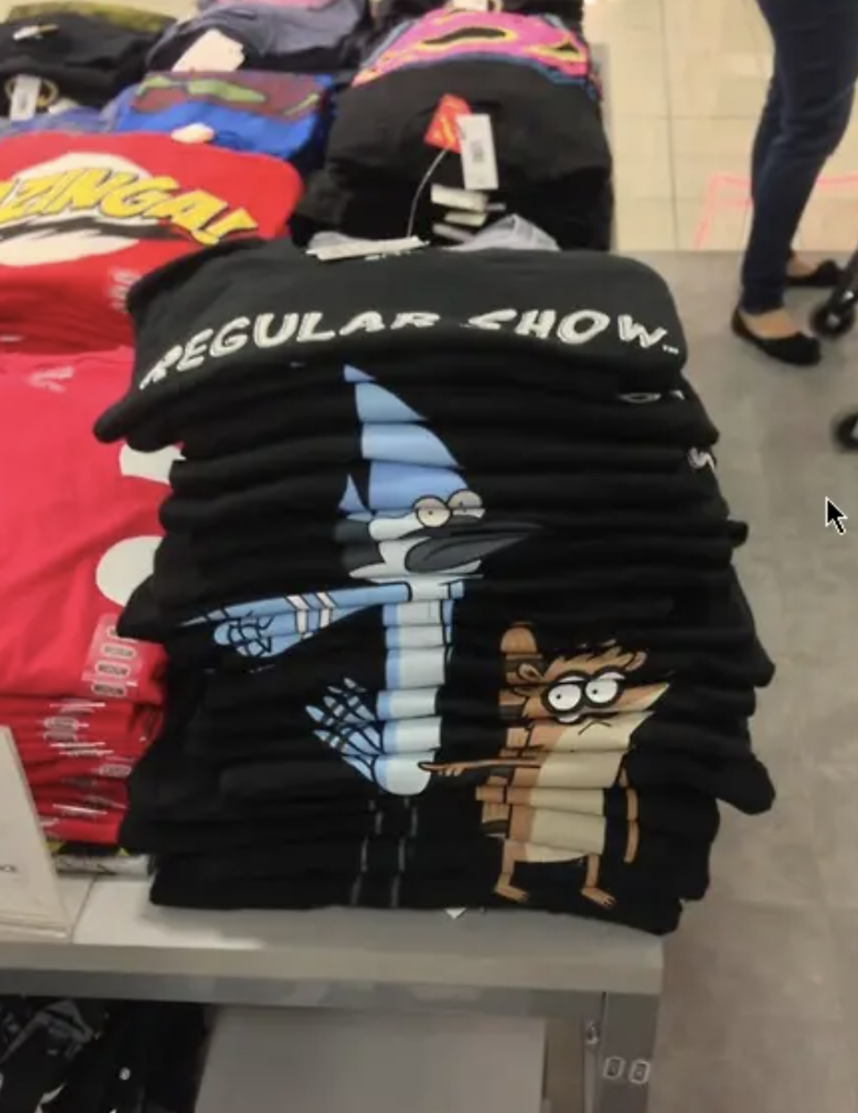 Stack of 'Regular Show' t-shirts featuring characters Mordecai and Rigby