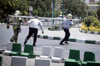 <p>Members of Iranian civil defence run during an attack on the Iranian parliament in central Tehran, Iran, June 7, 2017. (Photo: Tasnim News Agency/Handout via Reuters) </p>