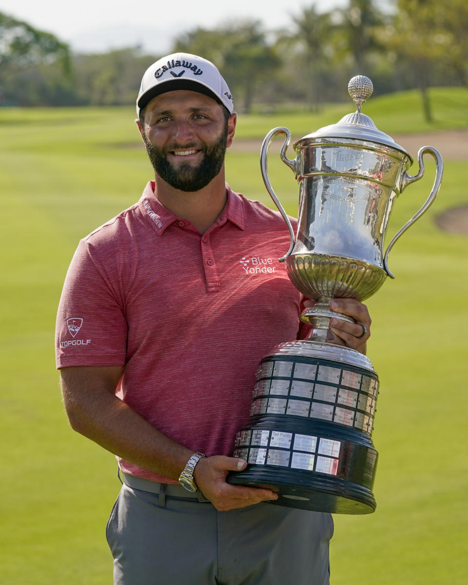 Jon Rahm, of Spain, holds the championship trophy after winning the Mexico Open at Vidanta, in Puerto Vallarta, Mexico, Sunday, May 1, 2022. (AP Photo/Eduardo Verdugo)