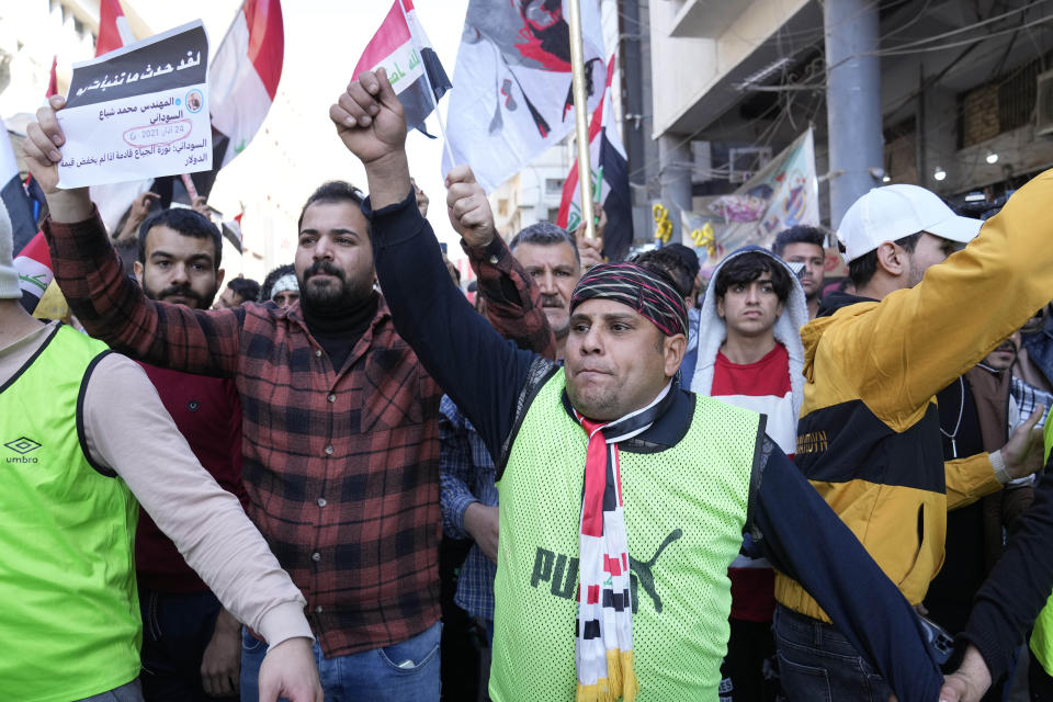 Demonstrators protest in front of the Iraqi central bank as currency plummets against the U.S. dollar, in Baghdad, Iraq, Wednesday, Jan. 25, 2023. (AP Photo/Hadi Mizban)