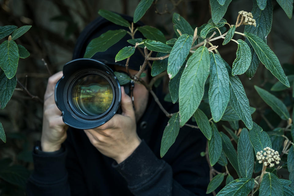 man sneakily taking photos