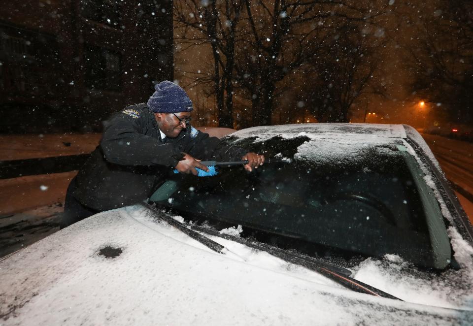 Rudolph Stone scrapped snow and ice off his car after running an errand and returning to a car covered in ice and snow again.  Plummeting temperatures complicated a system of snow and ice in Louisville, Ky. on Dec. 22, 2022.