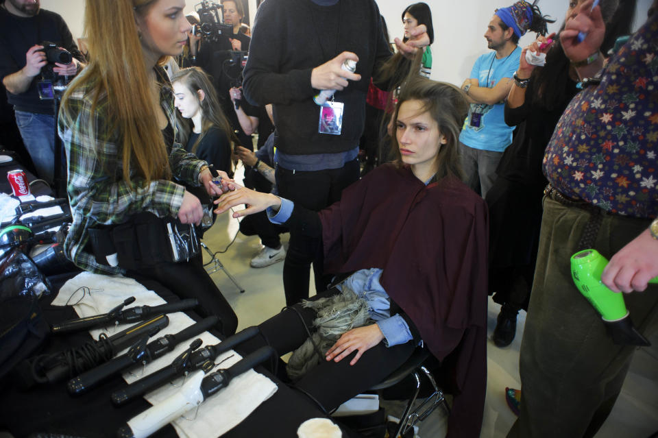 A model is prepared ahead of the Paul Smith collection during London Fashion Week, Sunday, Feb. 17, 2013, London. (Photo by Jonathan Short/Invision/AP)