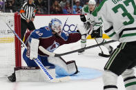 Colorado Avalanche goaltender Alexandar George (40) makes a glove save against the Dallas Stars during the first period of an NHL preseason hockey game Wednesday, Oct. 5, 2022, in Denver. (AP Photo/Jack Dempsey)