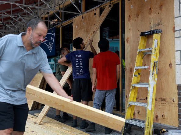 CLEARWATER BEACH, FLORIDA - AUGUST 29: Workers place protective plywood over the openings at Toucan's Bar & Grill before the possible arrival of Hurricane Idalia on August 29, 2023 in Clearwater Beach, Florida. Hurricane Idalia is forecast to make landfall on the Gulf Coast of Florida Wednesday morning. (Photo by Joe Raedle/Getty Images)