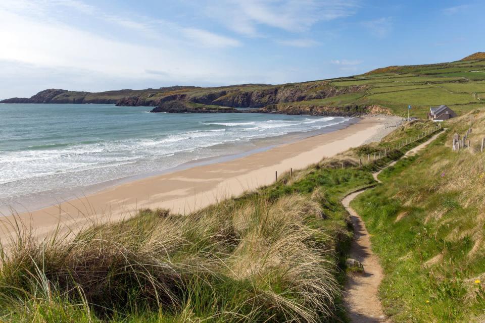 <p>A wide expanse of fine white sand with Blue Flag status, this glorious Pembrokeshire beach is one of the best surfing spots in the country. At the north end of Whitesands, there’s a rocky promontory to climb on and the quieter south end offers lovely sheltered bays.</p><p><strong>Where to stay:</strong> Wdig Farmhouse sleeps six people in the restored Grade II-listed Georgian farmhouse. It's just a short walk from the beach, with white panel floors and beams, a modern white-washed kitchen and an adjacent dining room conservatory. </p><p><a class="link " href="https://airbnb.pvxt.net/rnrgKd" rel="nofollow noopener" target="_blank" data-ylk="slk:SEE INSIDE">SEE INSIDE</a></p>