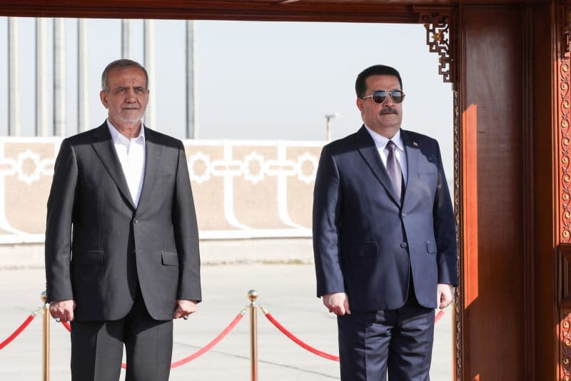 Iranian President Masoud Pezeshkian (left) is welcomed by Iraqi Prime Minister Mohammed Shia Al-Sudani in an official ceremony at Baghdad International Airport. Iranian Presidency/ZUMA Press Wire/dpa