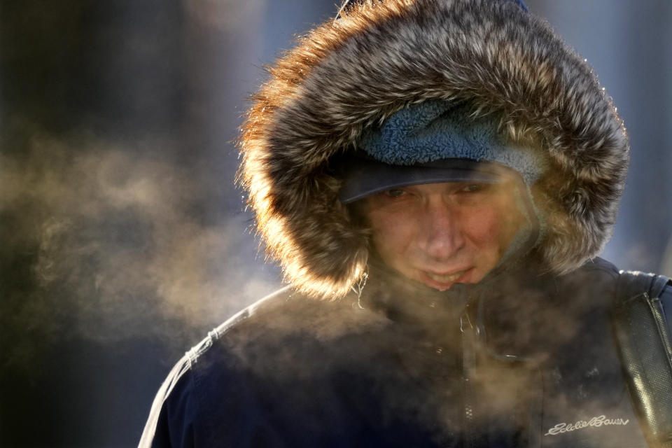 A passenger disembarks from a ferry arriving from Peaks Island, Saturday, Feb. 4, 2023, in Portland, Maine. The morning temperature was about -10 degrees Fahrenheit. (AP Photo/Robert F. Bukaty)