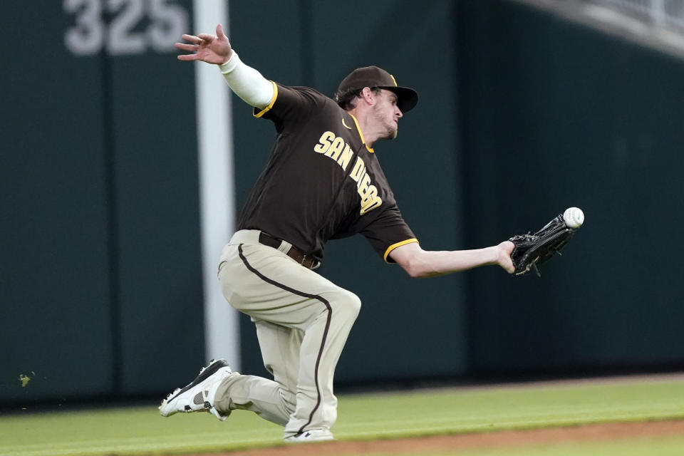 San Diego Padres right fielder Wil Myers (5) cannot catch a ball hit for a double by Atlanta Braves' Ozzie Albies in the sixth inning of a baseball game Friday, May 13, 2022, in Atlanta. (AP Photo/John Bazemore)