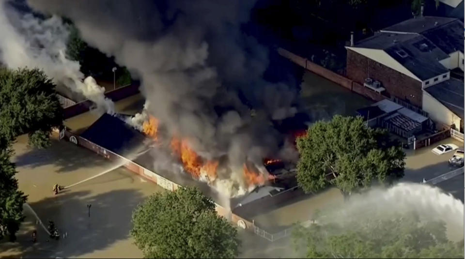 <p>This still image taken from video provided by KTRK-TV shows firefighters battling a blaze at a building still surrounded by Harveyâs floodwaters in Houston on Saturday, Sept. 2, 2017. Houston TV station KTRK reported Saturday that firefighters were being hampered by burglar bars on windows around the building, which appears to be a multi-family dwelling. Parts of west Houston are still inundated from the release of floodwater from nearby reservoirs that are designed to catch storm runoff. (Photo: KTRK-TV via AP) </p>