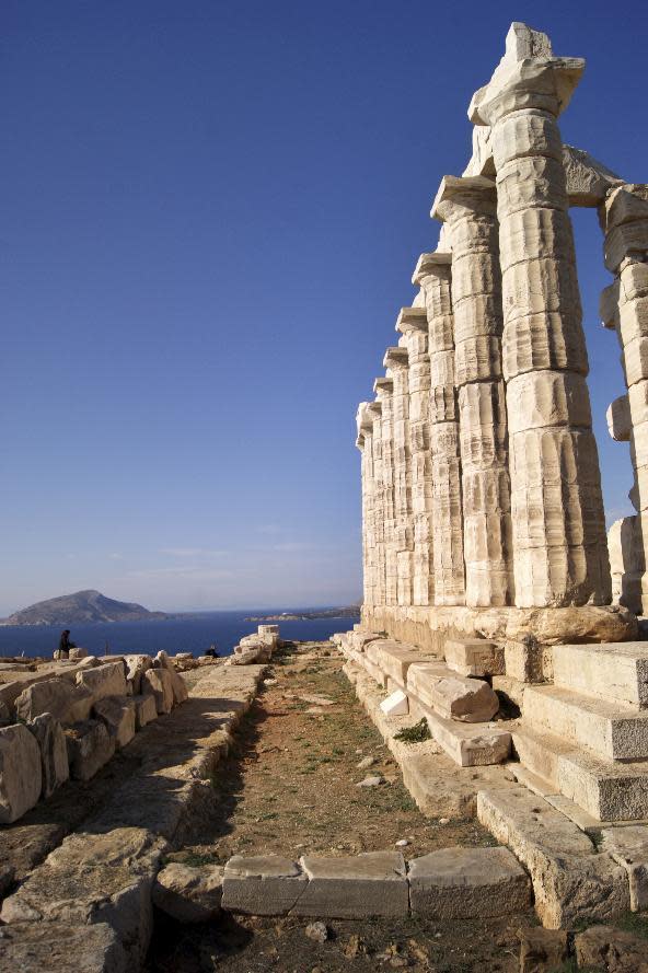 In this Dec. 12, 2016 photo, the Temple of Poseidon, an ancient hilltop structure the southern peninsula of Sounion dedicated to the god of the sea, is seen against a backdrop of the Aegean Sea. For travelers with more than beaches on their minds, there's plenty of upside to a brief winter visit to Athens that avoids the crowds and heat of summer. (Jerrin Heller via AP)