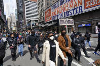 Protesters march past the Winter Garden Theatre in Times Square during a rally and march, Thursday, April 22, 2021, in New York. Hundreds of theater workers marched down Broadway on Thursday, rallying to demand more inclusion for minorities and the disabled, protesting producer Scott Rudin and to call for greater transparency from their union, Actors' Equity Association. (AP Photo/Mary Altaffer)