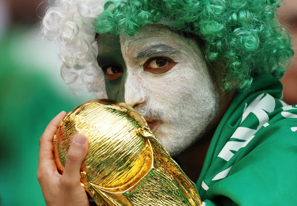 Soccer Football - FIFA World Cup Qatar 2022 - Group C - Poland v Saudi Arabia - Education City Stadium, Al Rayyan, Qatar - November 26, 2022 A Saudi Arabia fan with a replica World Cup trophy inside the stadium before the match REUTERS/Matthew Childs     TPX IMAGES OF THE DAY