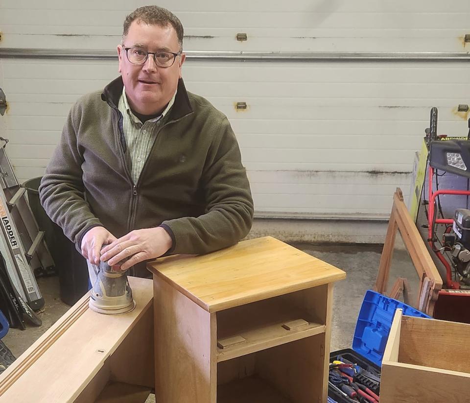 Tim Skelly, seen here at his home workshop, has been refurbishing furniture pieces he buys at auction for about 30 years.