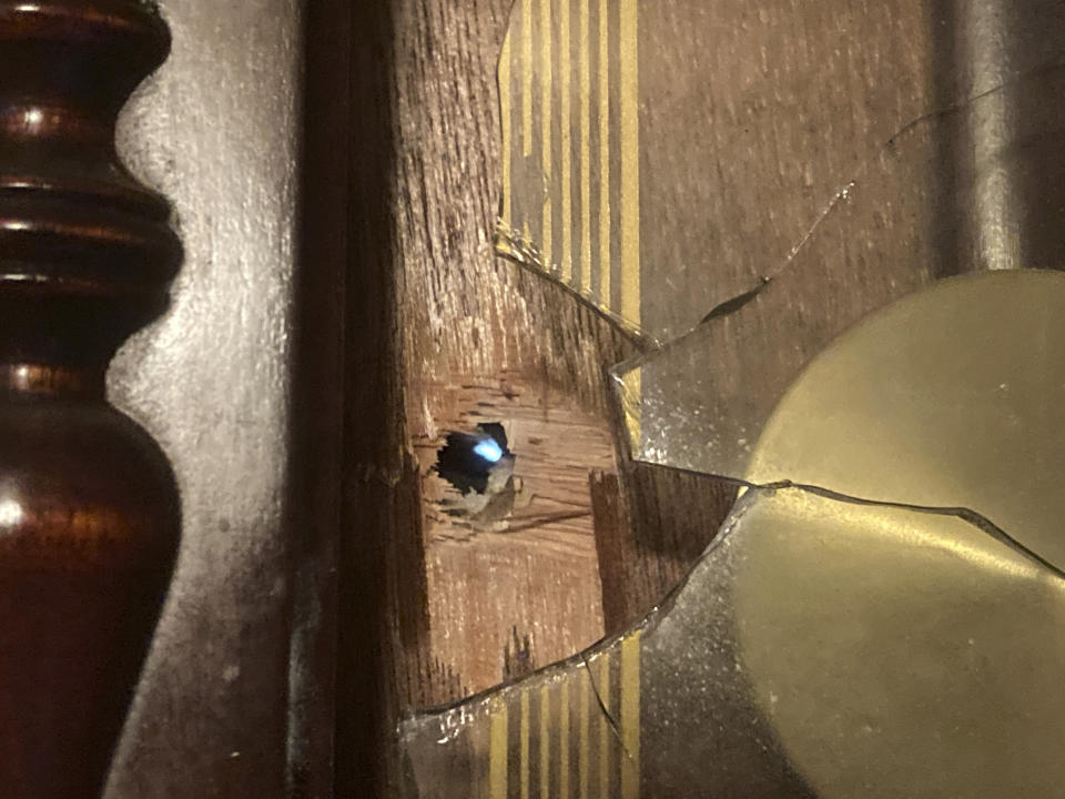 Daylight shines through a bullet hole in an antique clock on the living room wall of Michael Gordon's home in Elizabeth City, N.C., on Wednesday, April 21, 2021. Officers trying to serve a warrant on Andrew Brown Jr. fired at him as he was fleeing, striking Gordon's home. (AP Photo/Allen G. Breed)