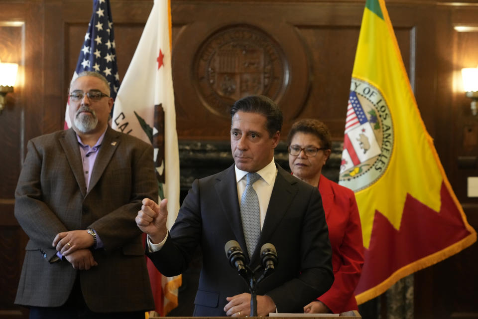 Los Angeles District Superintendent Alberto Carvalho,at podium, explains the terms of a new deal as SEIU Local 99 Executive Director Max Arias, left, and Los Angeles Mayor Karen Bass, right, announce a deal together in Los Angeles City Hall, Friday, March 24, 2023. The Los Angeles Unified School District and union leaders say they have reached a deal on a new contract for workers after a strike that shut down the nation's second-largest school system for three days. (AP Photo/Damian Dovarganes)