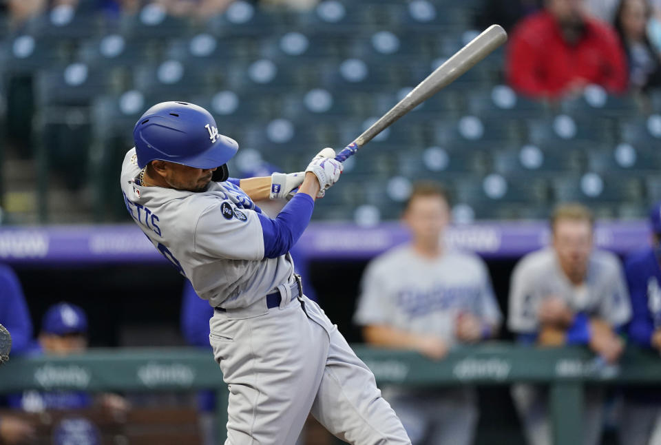 Los Angeles Dodgers' Mookie Betts connects for a double off Colorado Rockies starting pitcher Antonio Senzatela in the second inning of a baseball game Friday, April 2, 2021, in Denver. (AP Photo/David Zalubowski)