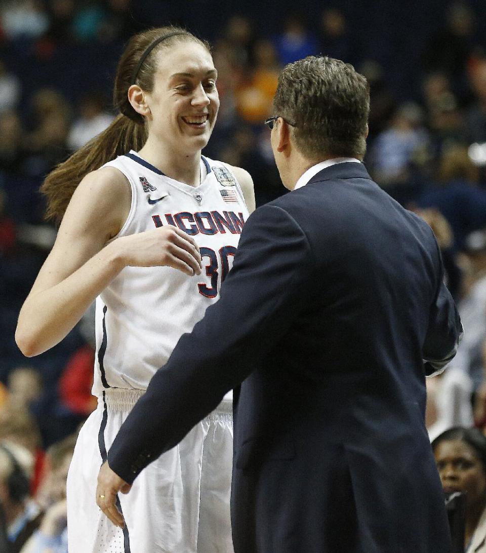 Connecticut forward Breanna Stewart (30) prepares to hug Connecticut head coach Geno Auriemma after the second half of the semifinal game in the Final Four of the NCAA women's college basketball tournament, Sunday, April 6, 2014, in Nashville, Tenn. Connecticut won 75-56. (AP Photo/John Bazemore)