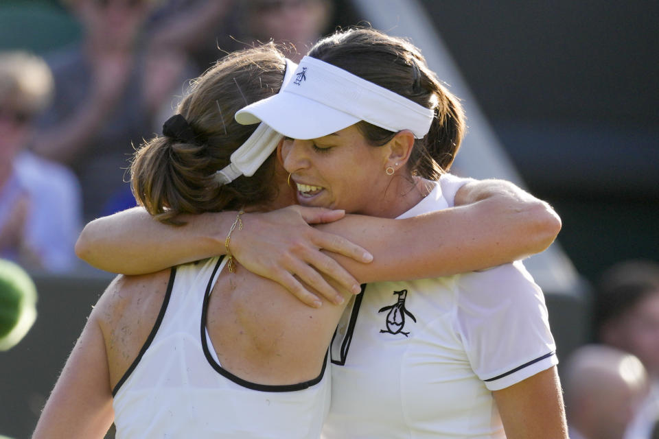 Australia's Ajla Tomljanovic, right, hugs France's Alize Cornet after defeating her during a women's singles fourth round match on day eight of the Wimbledon tennis championships in London, Monday, July 4, 2022. (AP Photo/Kirsty Wigglesworth)