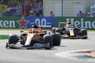 Mclaren driver Daniel Ricciardo of Australia steers his car in front of Red Bull driver Max Verstappen of the Netherlands during the Italian Formula One Grand Prix, at Monza racetrack, in Monza, Italy, Sunday, Sept.12, 2021. (AP Photo/Luca Bruno)