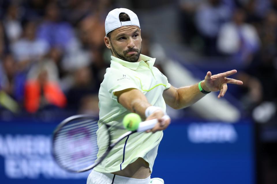 Grigor Dimitrov of Bulgaria returns a shot against Frances Tiafoe of the United States during their Men's Singles Quarterfinal match on Day 9 (Getty Images)