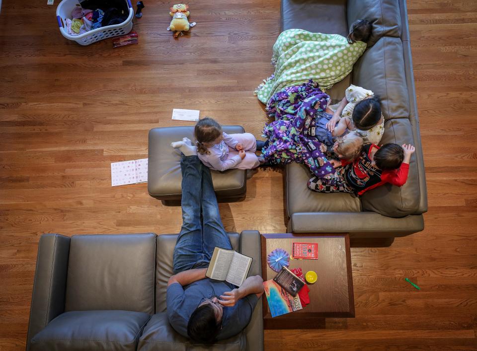 Rachael Denhollander and her husband, Jacob, share evening prayers and scripture discussion with their children.