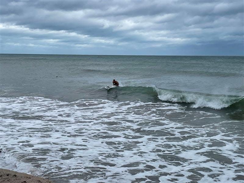 Ryan Smolen, of Stuart, tries to catch a wave on his surfboard as dozens flock to Jensen Beach Park after hurricane winds tore through the Treasure Coast on Sept. 28 and 29, 2022.