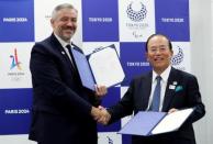 Etienne Thobois, Paris 2024 Director General, shakes hands with Toshiro Muto, Tokyo 2020 CEO, after signing documents during a ceremony marking conclusion of MoU between Tokyo 2020 and Paris 2024 Olympic Games in Tokyo, Japan, July 11, 2018. REUTERS/Kim Kyung-Hoon