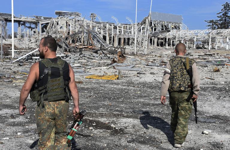 Pro-Russian militants survey the remains of Lugansk International Airport, eastern Ukraine, on September 11, 2014