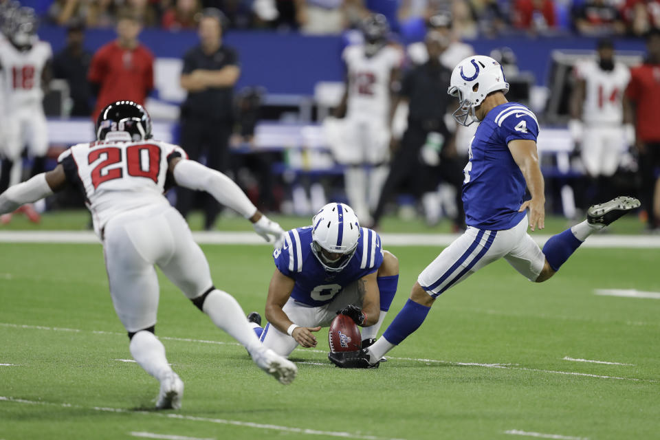 Indianapolis Colts kicker Adam Vinatieri, right, made his first field goal attempt of the game on Sunday. (AP)  