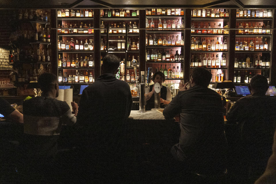 Patron seat at the bar at the Seven Grand, a whiskey bar downtown Los Angeles Tuesday, Feb. 28, 2023. Seven Grand offers an extensive selection of over 700 different whiskies from around the world, including rare and hard-to-find bottles. (AP Photo/Damian Dovarganes)