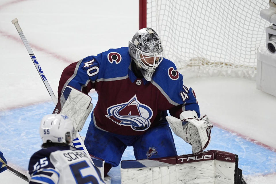 Colorado Avalanche goaltender Alexandar Georgiev stops a shot by Winnipeg Jets center Mark Scheifele during the third period of Game 3 of an NHL hockey Stanley Cup first-round playoff series Friday, April 26, 2024, in Denver. (AP Photo/David Zalubowski)