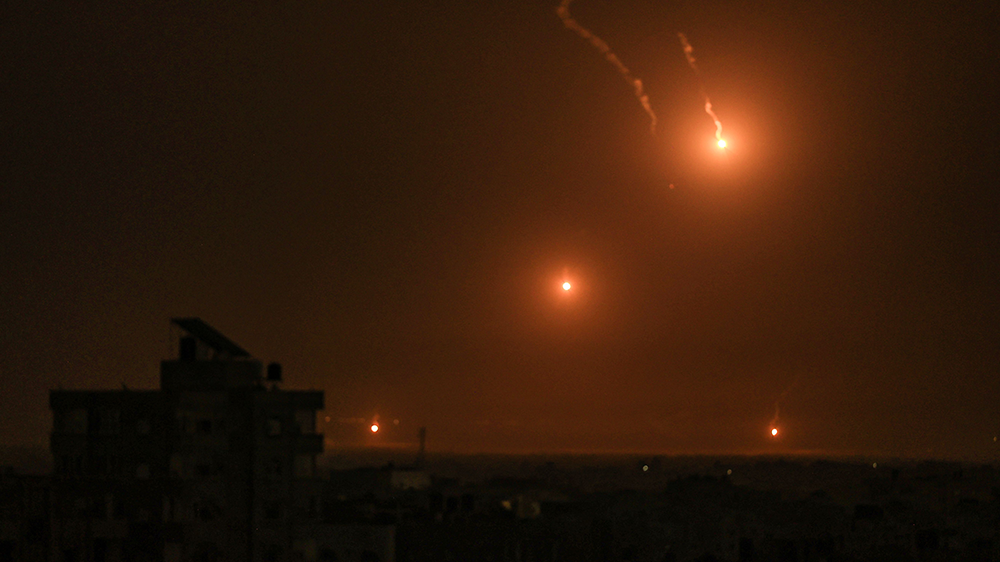 Flares fired by the Israeli army light up the sky east of Khan Yunis on the southern Gaza Strip (SAID KHATIB/AFP via Getty Images)