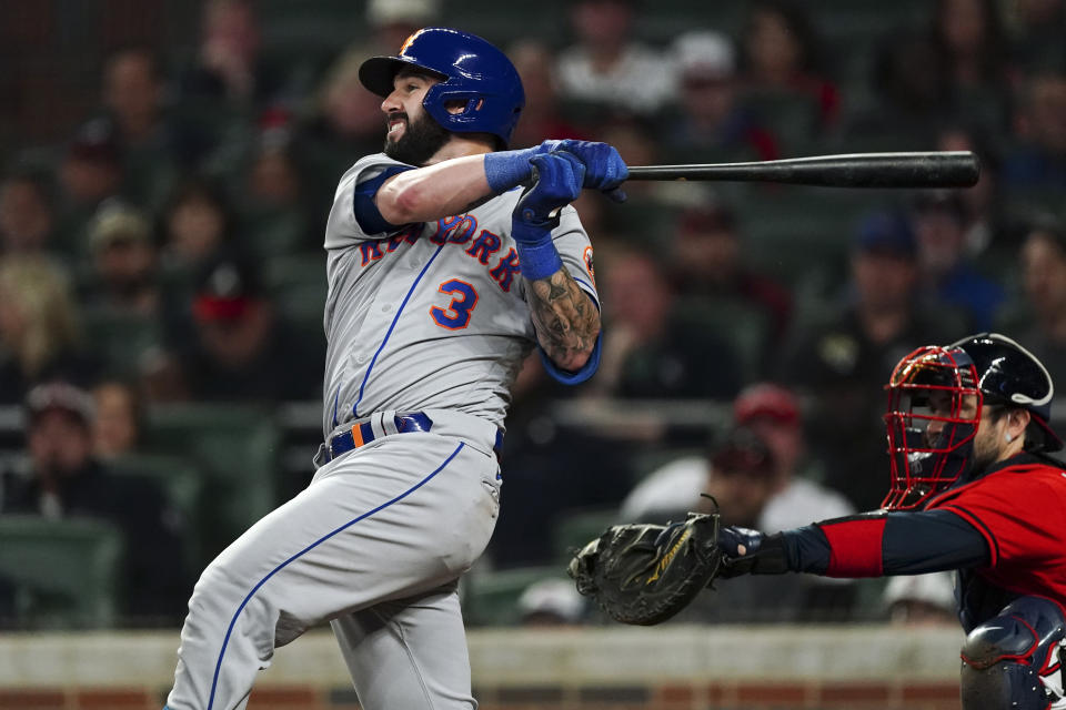 New York Mets' Tomas Nido watches his home run next to Atlanta Braves catcher Travis d'Arnaud during the eighth inning of a baseball game Friday, Sept. 30, 2022, in Atlanta. (AP Photo/John Bazemore)