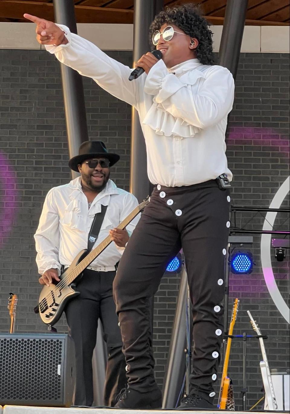 Shane Golden, of The Prince Project, points at the crowd while singing during the tribute band's concert Saturday at the Jackson Amphitheater.