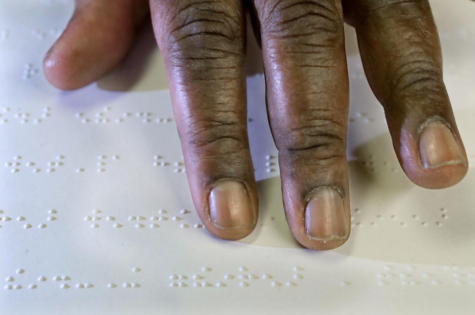 Akron Blind Center member Brian Banks learns to read Braille  on Thursday, Dec. 22, 2022, in Akron.