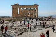 FILE PHOTO: People visit the ancient Parthenon Temple atop the Acropolis hill archaeological site in Athens