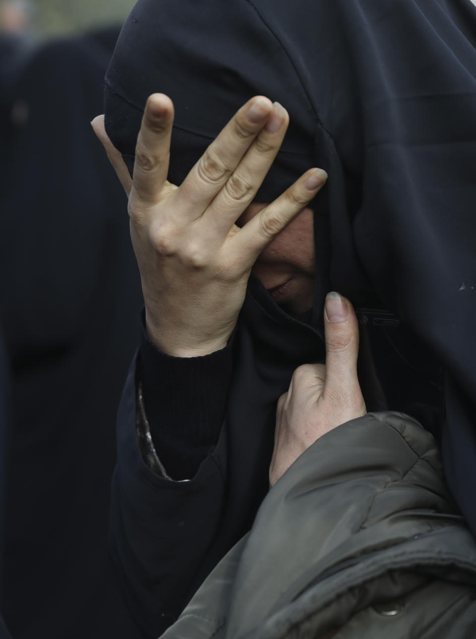 A woman mourns in a demonstration over the U.S. airstrike in Iraq that killed Iranian Revolutionary Guard Gen. Qassem Soleimani in Tehran, Iran, Jan. 3, 2020. Iran has vowed "harsh retaliation" for the U.S. airstrike near Baghdad's airport that killed Tehran's top general and the architect of its interventions across the Middle East, as tensions soared in the wake of the targeted killing. (AP Photo/Vahid Salemi)
