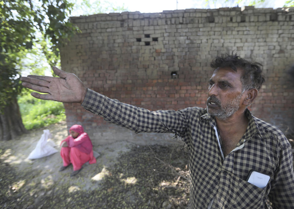 Indian farmer Pawan Kumar, 52, a fruit and vegetable farmer who hasn't joined the ongoing farmers protests, gestures towards his field in village Samrodha, in the northern Indian state of Haryana, Friday, March 5, 2021. Thousands of demonstrating Indian farmers blocked a massive expressway on the edges of capital New Delhi on Saturday to mark the 100th day of protest against agricultural laws passed last year that they say will devastate their income. But not all farmers are against the laws. Kumar, an ardent Modi supporter, said he was ready to accept the laws. "If they turn out to not benefit us, then we will protest again. We will jam roads, and make that protest even bigger than this. Then more common people, even workers, will join that protest. But if they turn out to be beneficial for us, we will keep them," Kumar said talking about the new laws. (AP Photo/Manish Swarup)