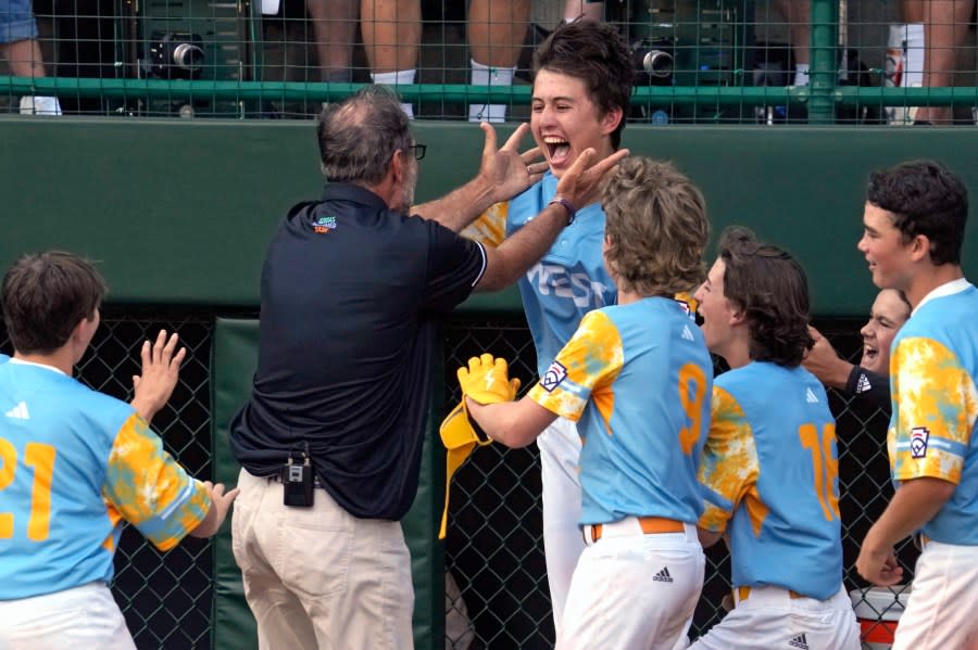 El Segundo, Calif.’s Louis Lappe, right center, celebrates with manager Danny Bole, left center, and teammates after hitting a solo walk-off home run off Curacao’s Jay-Dlynn Wiel during the sixth inning of the Little League World Series Championship game in South Williamsport, Pa., Sunday, Aug. 27, 2023. California won 6-5. (AP Photo/Gene J. Puskar)